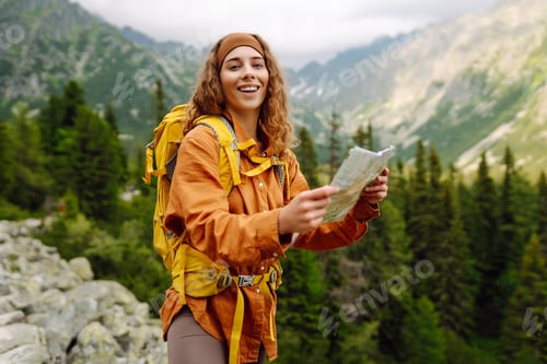 Preview: The adventure begins! Beautiful woman traveler with a yellow backpack, holds a map. Vacation concept