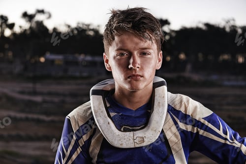 Preview: Passion comes with a bit of dirt. Portrait of a dirtbike race standing in his race gear.