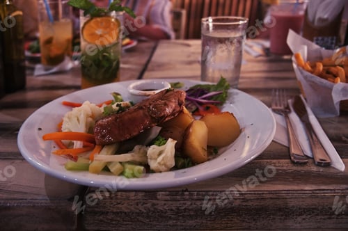 Preview: Tuna steak with potatoes and vegetables on rustic table