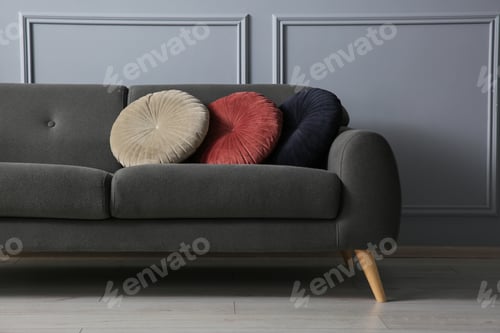 Preview: Stylish sofa with cushions near grey wall