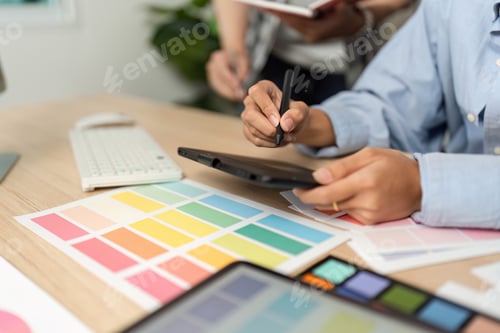 Preview: Creative Process in UX and UI Design. Designer working on a tablet with color swatches.