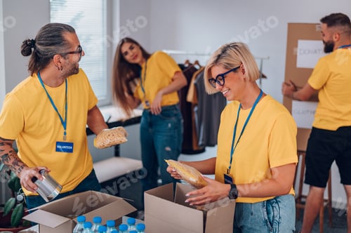 Preview: Group of volunteers working in community charity donation center