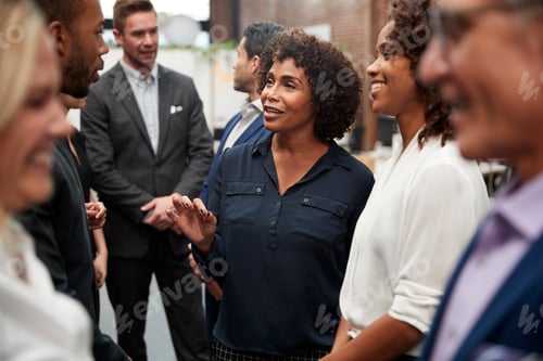 Preview: Business Team Standing Having Informal Meeting In Modern Office