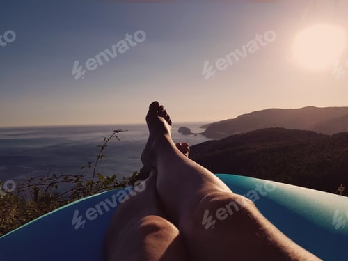 Preview: Relaxing in the sun on an airbed, overlooking the ocean