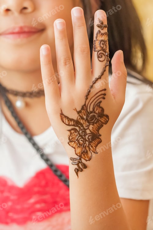 Preview: Beautiful henna art on a hand of a girl, closeup