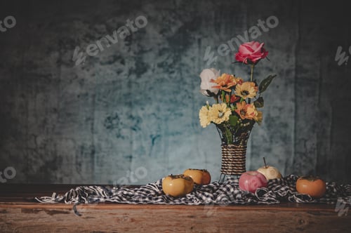 Preview: Still life with a vase of flowers and fruit placed on a fabric