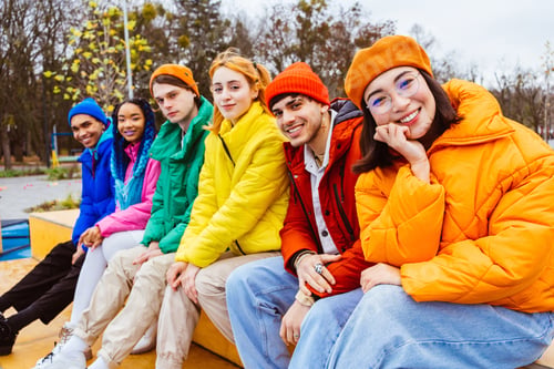 Preview: Multiracial group of young friends meeting outdoors in winter