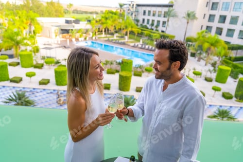 Preview: Newlywed couple toasting on the terrace of a luxury hotel