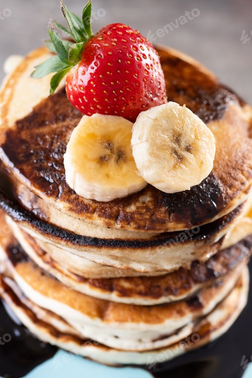 Preview: Pancakes with chocolate and fruit on wooden table