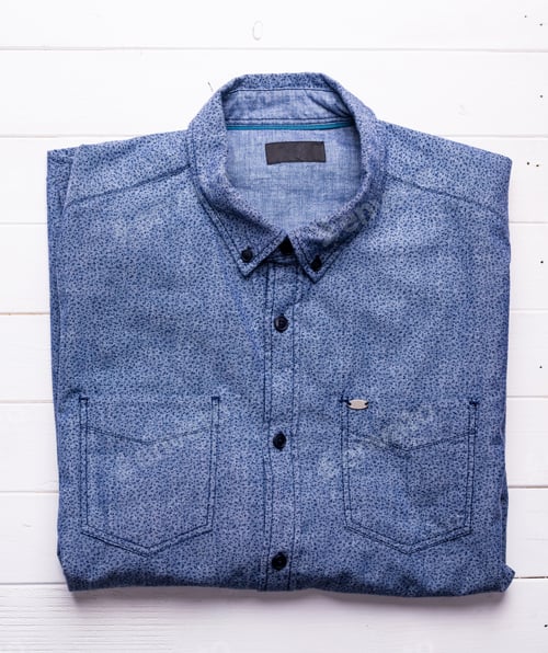 Preview: Folded Blue Patterned Shirt on a White Background