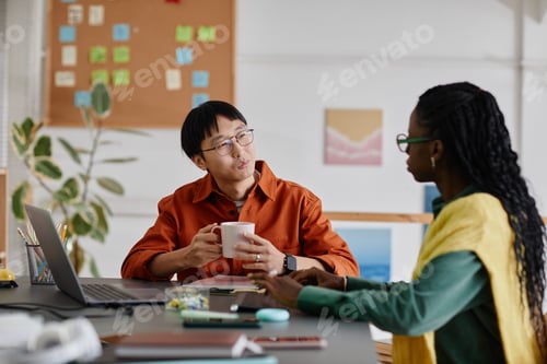 Preview: Conversing in Modern Office Setting Near a Desk
