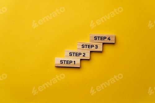 Preview: a yellow warm background without shadows wooden cubes with black letters laid out word steps