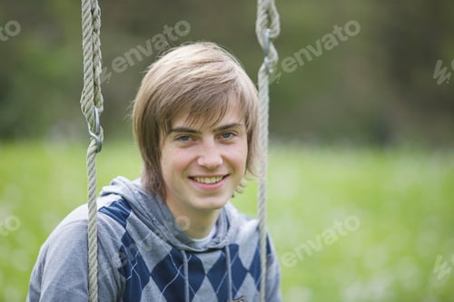 Preview: boy sitting on a swing
