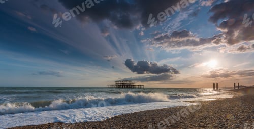 Preview: Beautiful foamy waves of the sea coming to the shore under the amazing clouds in the sky