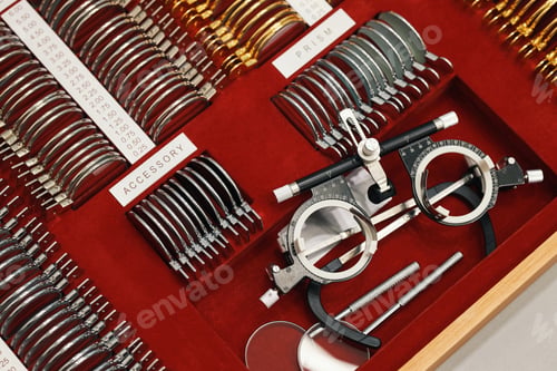 Preview: Optometry Trial Lens Set and Test Frame Arranged on Red Velvet Display