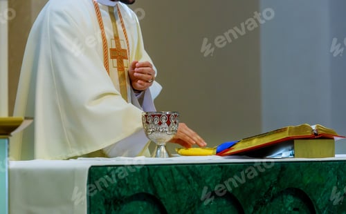 Preview: Holy communion on table in church cup of glass with red wine, and Holy Bible