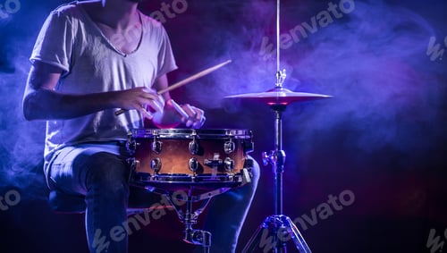 Preview: A drummer plays drums on a blue background.