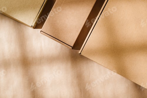 Preview: Brown cardboard boxes arranged on a neutral background in a warehouse setting during daylight hours