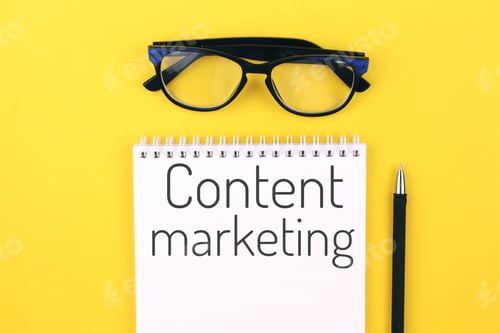 Preview: notebook with word content marketing on a yellow background