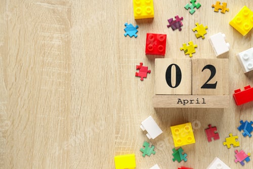 Preview: Multicolored puzzle pieces and legos on a light background, place for text. World autism day concept