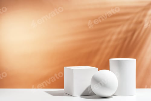 Preview: White geometric shapes arranged stylishly on a soft peach background in a minimalist setting