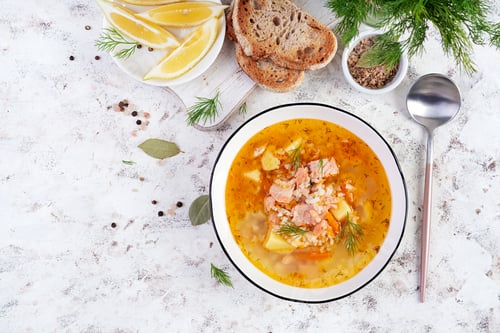 Preview: Fish soup with salmon, vegetables and rice in white bowl. Salmon soup.