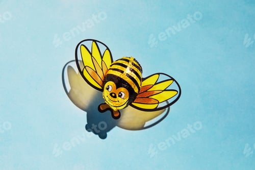 Preview: Candy cane bee with shadow. The concept of the Rosh Hashanah holiday - the Jewish New Year