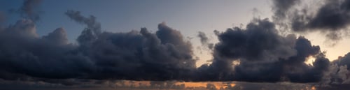 Preview: Dramatic Panoramic View of a cloudscape during a dark, rainy and colorful sunrise