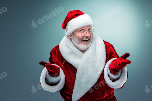 Preview: A Happy, Smiling Santa Claus In Glasses With A Gray Beard On A Blue Background