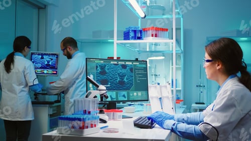 Preview: Chemist nurse sitting in scientific lab examining virus evolution