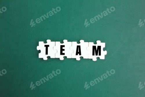 Preview: white puzzle with the word team. group concept or group cooperation. Concep of team work and team pl