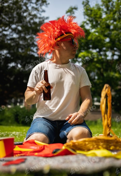 Preview: Portrait of a young man with beer celebrating belgium day.
