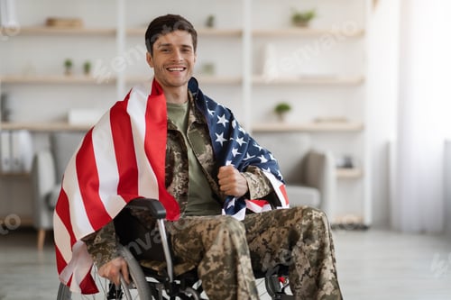 Preview: Cheerful military guy in wheelchair with flag of the US
