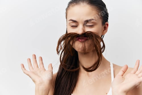 Preview: Fun, humor, playful, beauty, expressions A young woman playfully poses with her long hair styled