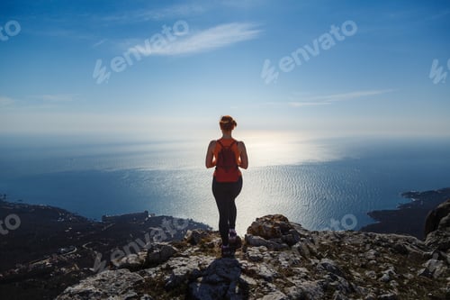 Preview: young fitness woman trail runner on sunrise seaside trail