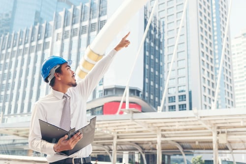 Preview: Civil construction engineer working with laptop at desk office with white yellow safety hard hat