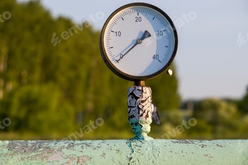 Preview: Old pressure gauge on an old pipe.