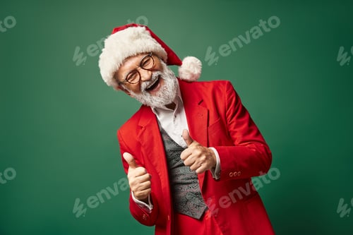 Preview: happy jolly Santa showing thumbs up gesture and smiling cheerfully at camera, Christmas concept