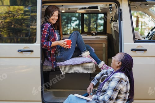 Preview: Mature multiracial female friends having fun during travel vacation with mini van camper