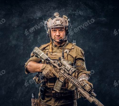 Preview: Elite unit, special forces soldier in camouflage uniform posing with assault rifle.
