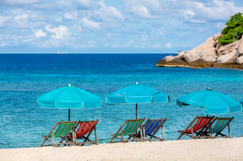 Preview: Beach chairs on the white sand beach and umbrella, Wooden deck chairs on sandy beach near sea.