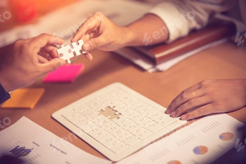 Preview: two businesswomen trying to connect couple puzzle piece , one part of whole.