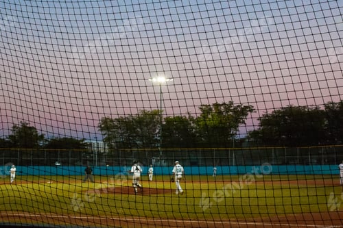 Preview: Sunset over high school kids on a baseball field playing in a game