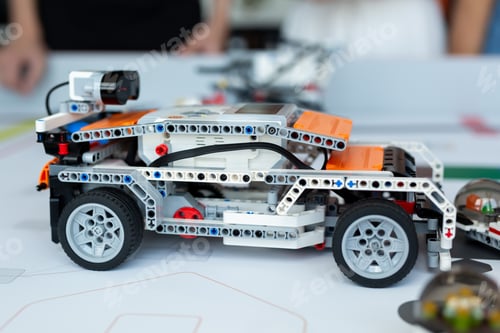 Preview: Close-up children control cars robots assembled from a constructor programmed