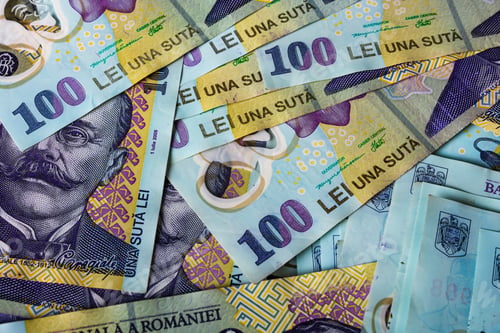 Preview: Closeup of the Romanian LEI bill pile spread on a table