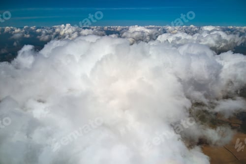 Preview: Aerial view from high altitude of earth covered with puffy rainy clouds forming before rainstorm