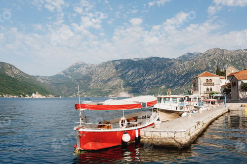 Preview: Row of boats are moored at the pier in the Kotor Bay off the coast of Perast. Montenegro