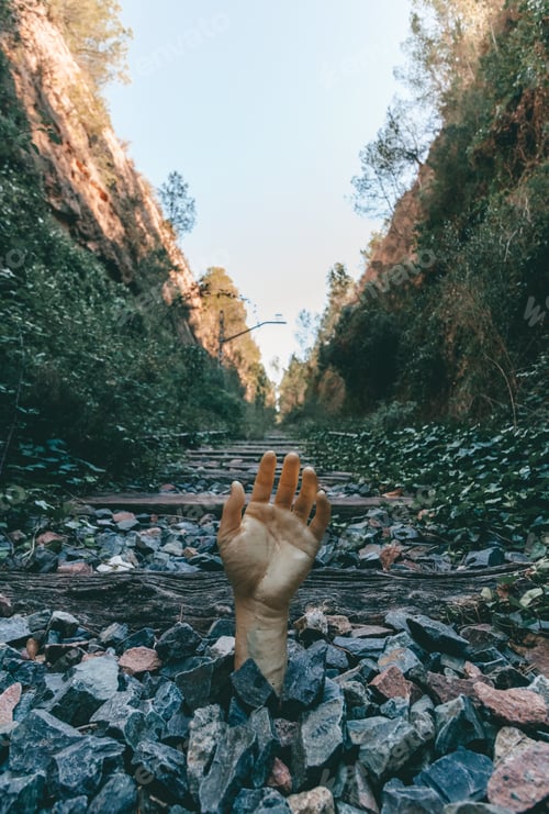 Preview: Hand coming out of a stone pile