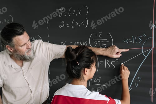 Preview: Asian Teenager Student doing Maths Exercises on Blackboard with teacher help in High School