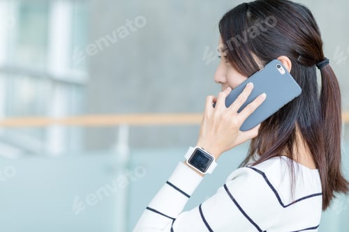 Preview: Woman chat on mobile phone and wearing smart watch